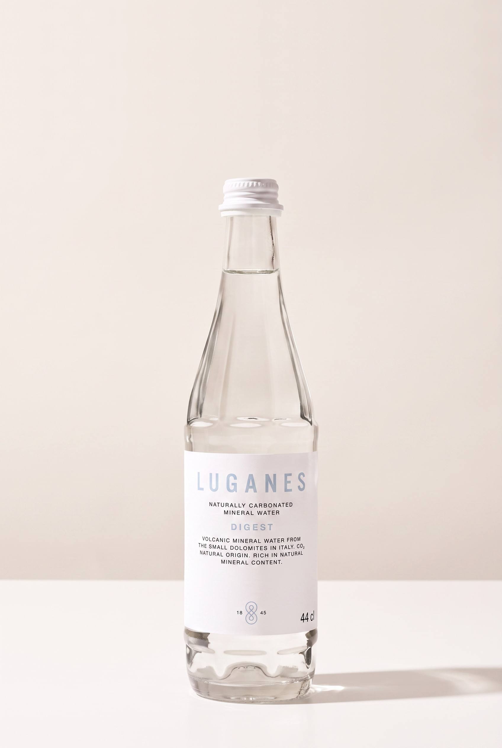 LUGANES Digest bottle on white with a deeper shadow and gold label detail